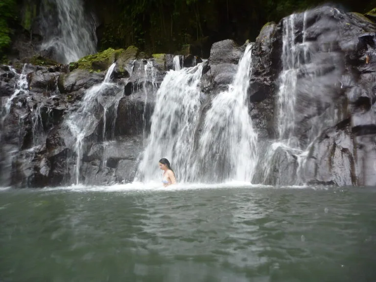 scarlet under a waterfall