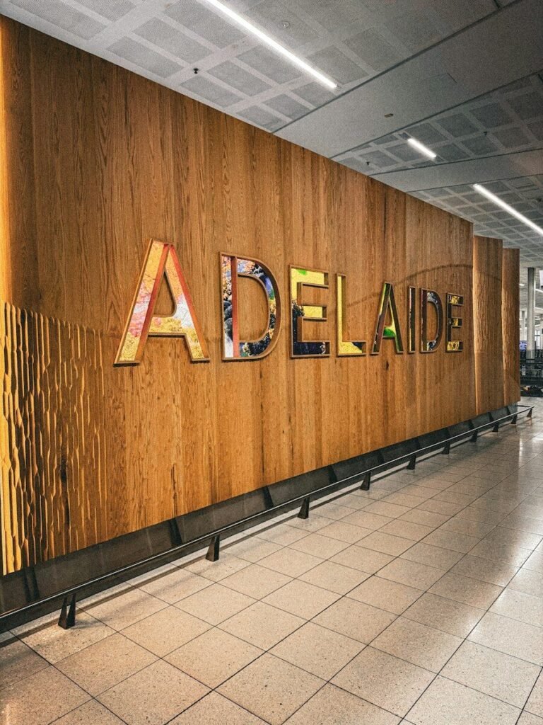 Colorful adelaide sign on a textured wooden wall