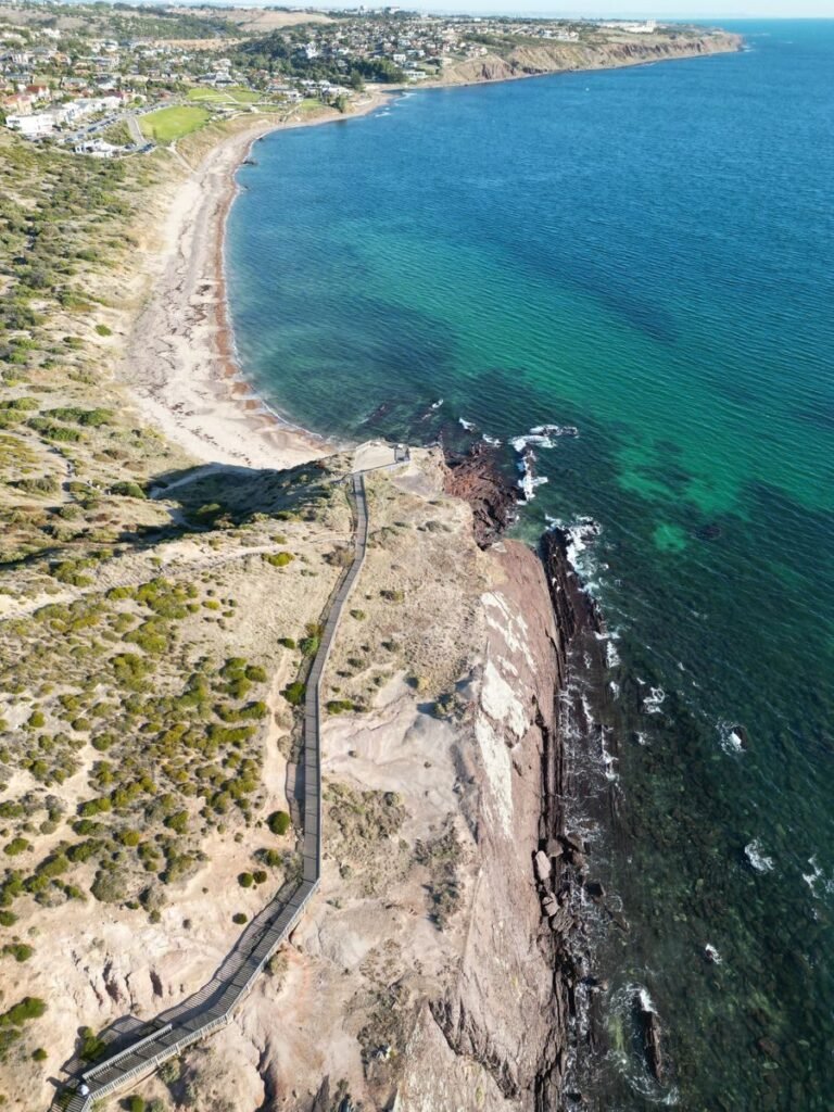 Stunning aerial shot of Hallett Cove's rugged coastline and clear blue waters in South Australia.