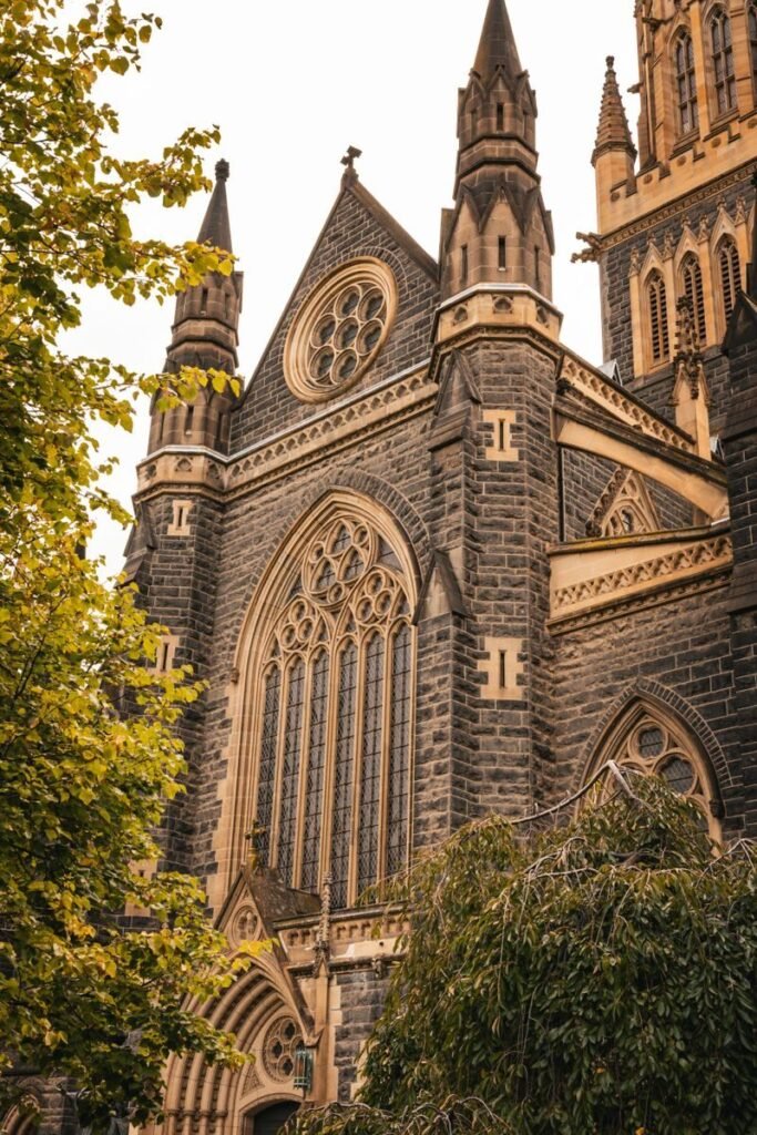 Stunning view of the Gothic Revival St Patrick's Cathedral in Melbourne, showcasing intricate stonework and towering spires.